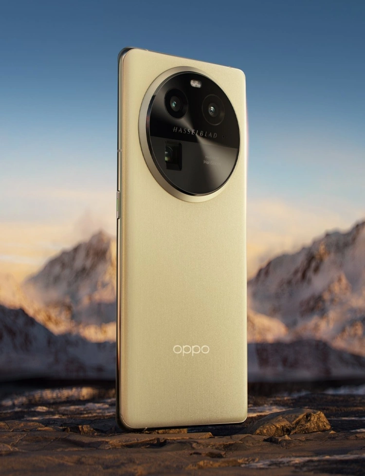 Smartfon OPPO Find X6 Pro w kolorze żółtym na tle gór.